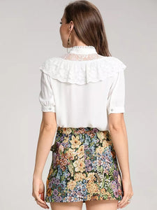 White blouse with detailed floral tapestry skirt
