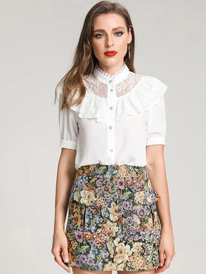 White blouse with detailed floral tapestry skirt