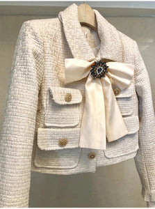 The Cream tweed two piece with bow and brooch